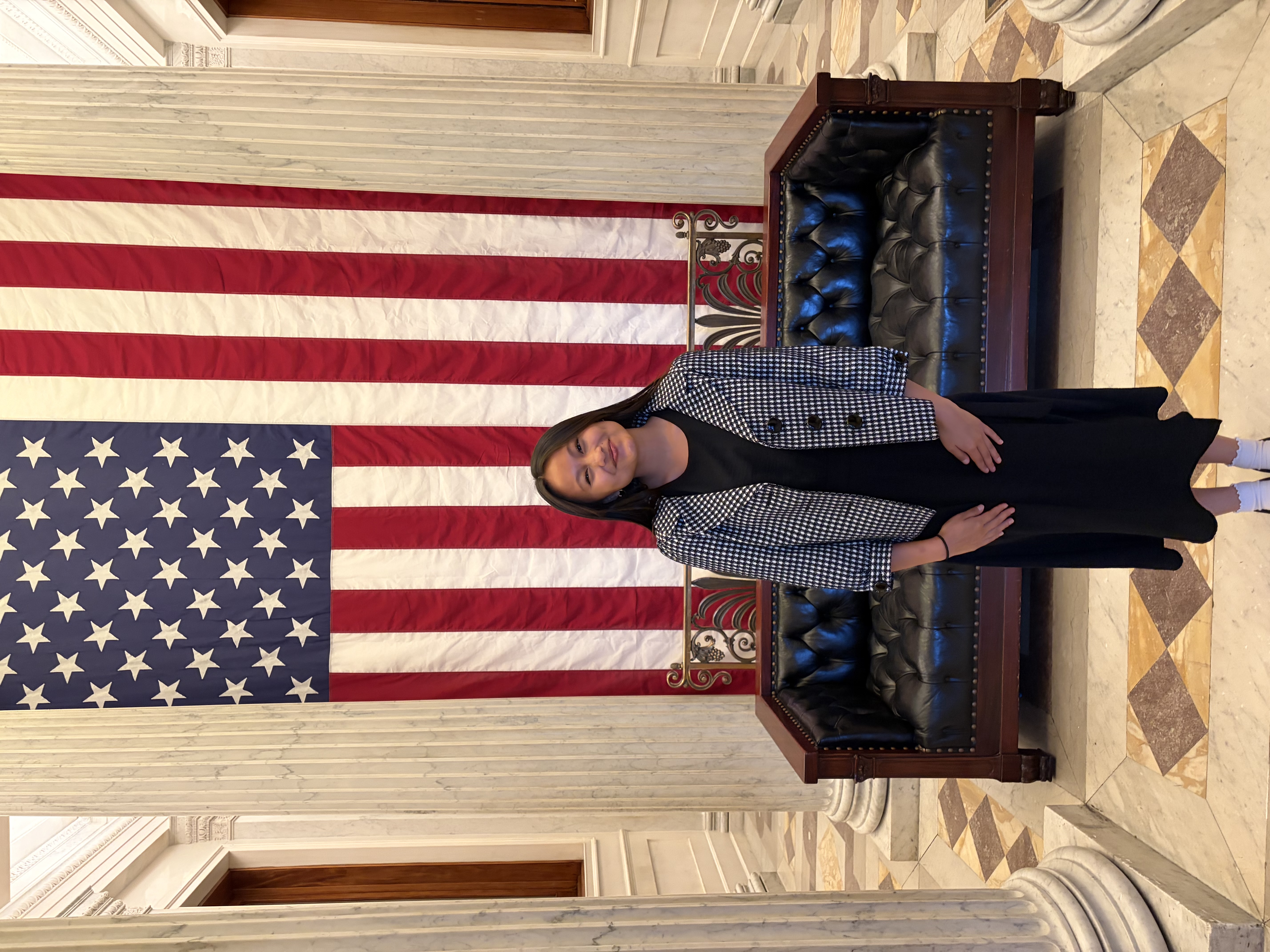 Grace posing in front of US flag
