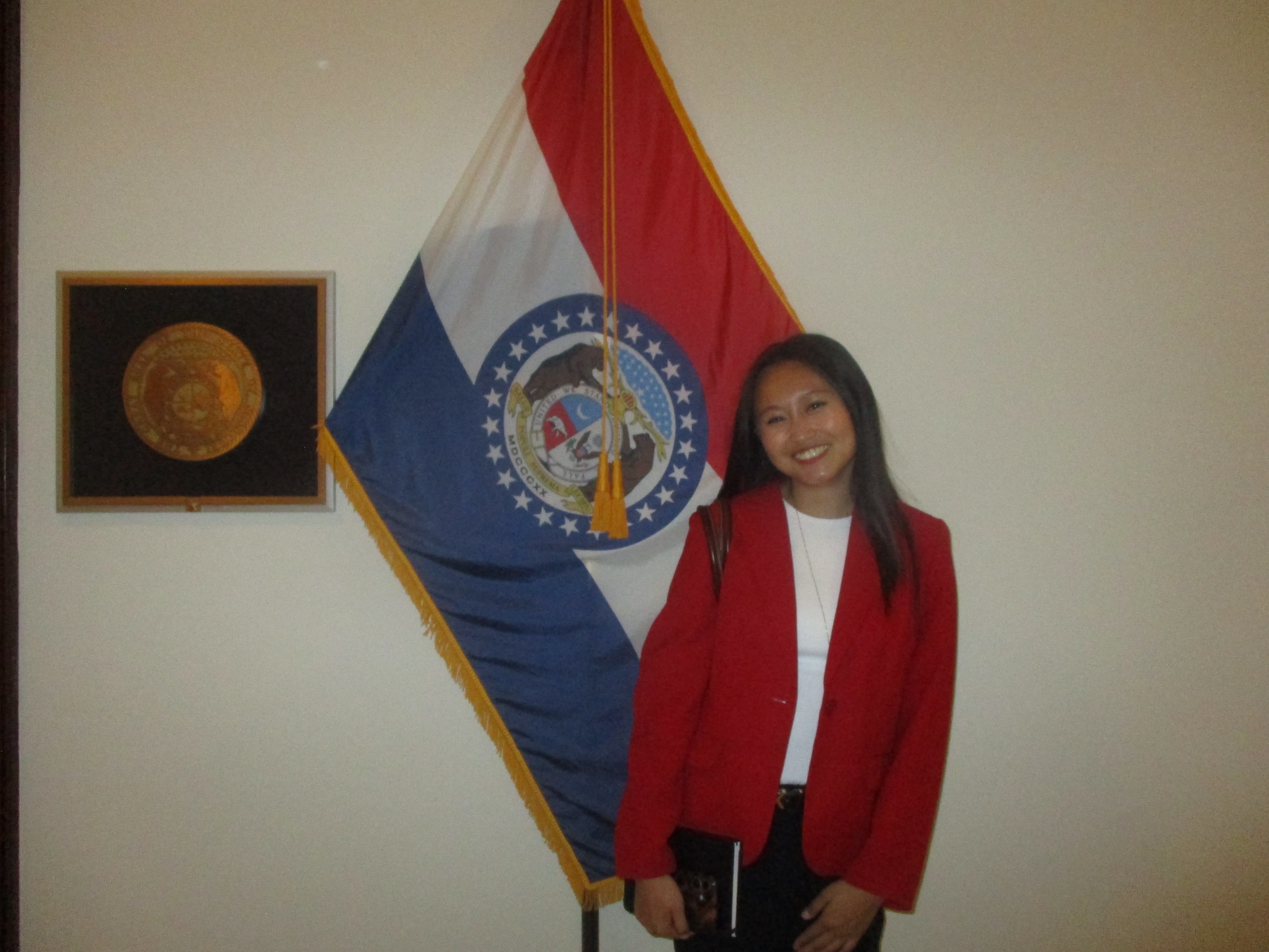 Grace posing in front of Missouri state flag